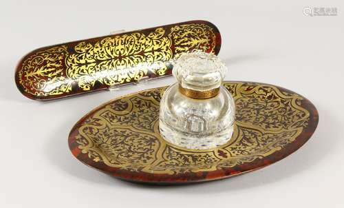 A GOOD BOULLE BRASS INLAID OVAL INKSTAND with glass inkwell and pen tray. 27cms long.