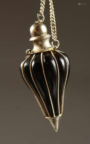 A SILVER MOUNTED HORN SNUFF BOTTLE with chain.