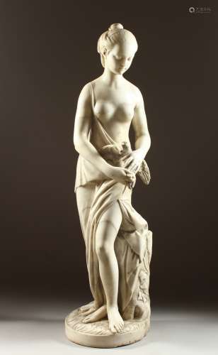 A SUPERB ITALIAN CARVED WHITE MARBLE STANDING SEMI-NUDE holding a dove, beside a plinth carved