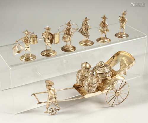 A CHINESE SILVER SALT AND PEPPER SET as a man pulling a cart, along with six silver menu holders (7)
