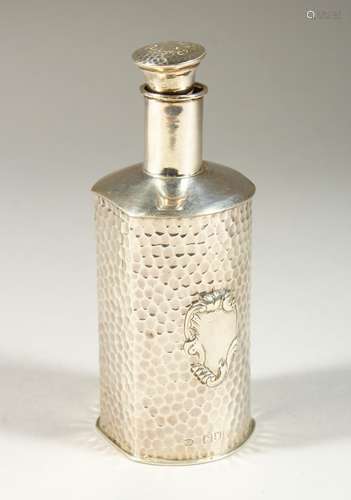 A VICTORIAN HAMMERED SILVER SCENT BOTTLE AND STOPPER. London 1900. Maker W. COMYNS. 13cms high.