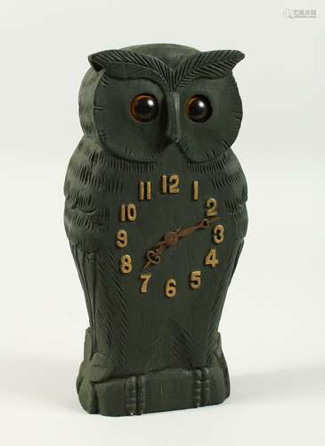 AN AMUSING CARVED WOOD OWL CLOCK with moveable eyes. 24cms high.