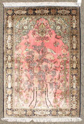 A FINE PERSIAN SILK QUM RUG with a tree pattern and mtifs to the border. 5ft 1in x 3ft 6ins.
