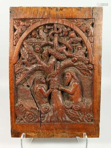 A 17TH / 18TH CENTURY FLEMISH OAK CARVED PANEL, depicting Adam and Eve beneath the apple tree in the