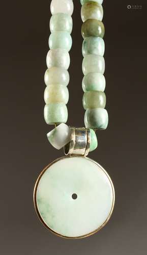 A GOOD HEAVY JADE NECKLACE with circular pendant.