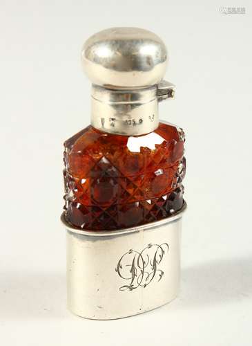 A 19TH CENTURY CONTINENTAL CUT AMBER-COLOURED GLASS SCENT FLASK AND STOPPER with silver cap and cup.