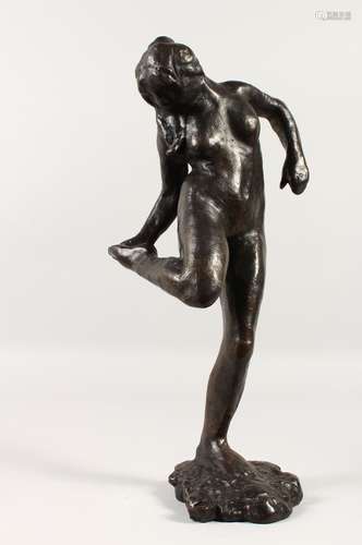 AFTER EDGAR DEGAS (1934-1917) FRENCH. A LARGE BRONZE OF A DANCER looking at her foot.. Signed Degas.