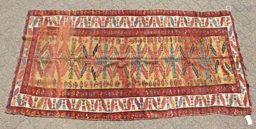 AN OLD CAUCASIAN RUNNER with typical motifs within a triple row border. 8ft 6ins x 4ft 4ins.