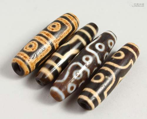 FOUR AGATE TIBETAN BEADS.