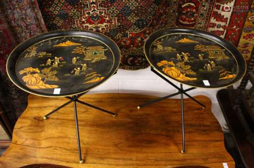 A PAIR OF CIRCULAR TOLEWARE TABLES on folding stands. 1ft 7ins diameter.