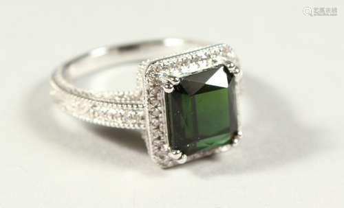 A 14k WHITE GOLD AND DIAMOND RING set with an emerald cut green tourmaline.