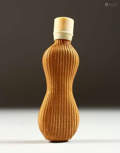 AN ART DECO BABY SHAPED SCENT BOTTLE with screw ivory cap. 8cms long.