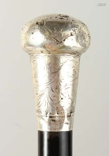 AN EARLY 20TH CENTURY WALKING STICK with engraved silver handle. 92cms long.