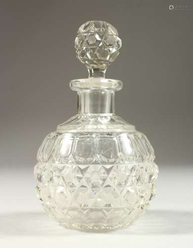 AN EDWARDIAN CUT GLASS GLOBULAR SCENT BOTTLE AND STOPPER. 14cms high.