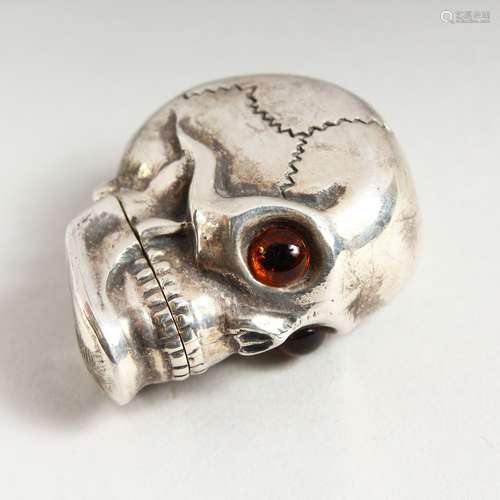 A NOVELTY SILVER SKULL VESTA CASE with glass eyes. 4cms.