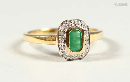 A 9CT GOLD EMERALD CUT EMERALD AND DIAMOND RING, boxed.