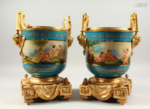 A APIR OF LOUIS XVITH SEVRES STYLE GILT METAL MOUNTED TWO HANDLED JARDINIERES painted with a