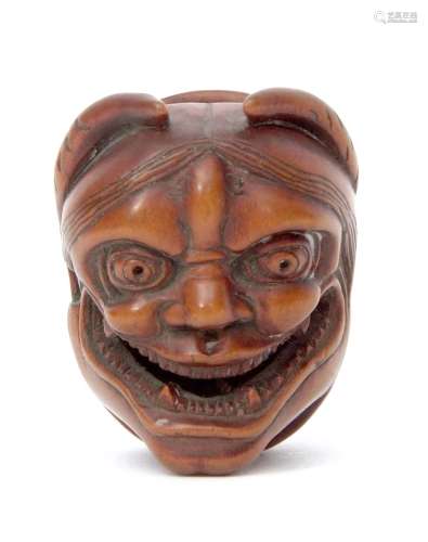 Japanese wooden netsuke finely modelled with a lady's smiling face to one side, the other wide