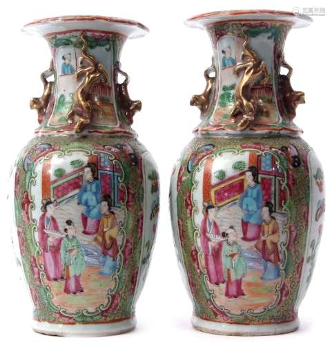 Pair of 19th century Cantonese vases with typical famille rose style decoration on a green and