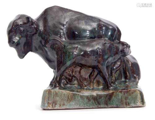 Pottery study of a bison group in mottled brown and green glaze by Stella R Crofts, signed to