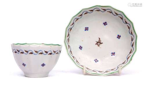 Lowestoft fluted tea bowl and saucer circa 1790, decorated in polychrome with Chantilly sprig design