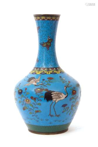 Japanese cloisonne baluster vase decorated with flying cranes and floral decoration on a blue