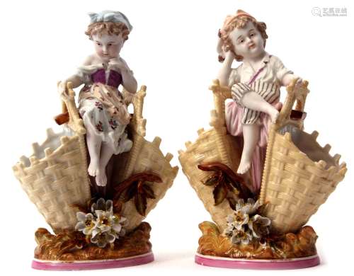 Pair of 19th century KPM porcelain flower holders modelled as a boy and a girl flanked by two flower