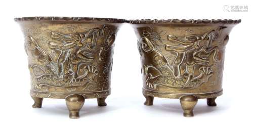 Two Oriental brass jardinieres decorated with dragons, on three stub feet with reign mark to base,