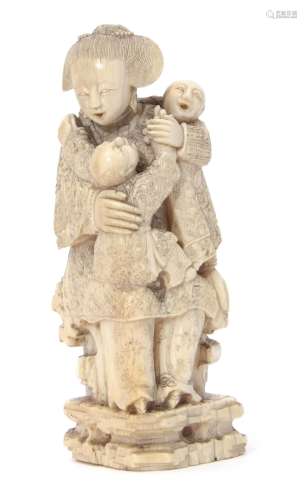 Japanese Meiji period ivory Okimono, modelled as a lady seated on a bench with two children, 11cm