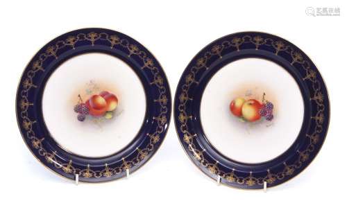 Pair of Royal Worcester plates painted with fruit by Townsend, within gilt blue borders, 23cm