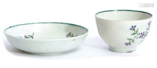 Lowestoft tea bowl and saucer decorated in polychrome with a Derby sprig design beneath a green line