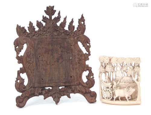 Asian ivory panel with wooden frame, carved with a figures on a cart, pulled by oxen