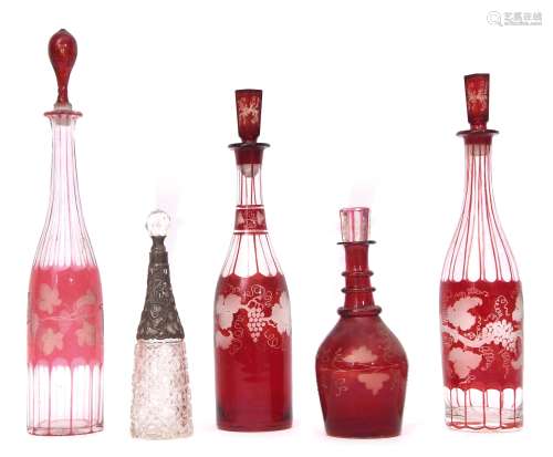 Collection of 19th century decanters, four cranberry coloured with fruiting vine design together
