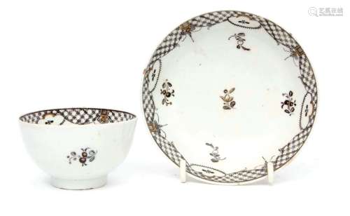 Lowestoft tea bowl and saucer circa 1780, with a black pencilled decoration of floral sprigs