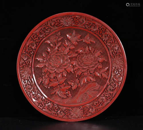 A LACQUER CARVED FLOWER PATTERN PLATE