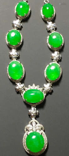 A GREEN JADEITE CARVED CIRCLE NECKLACE, TYPE A