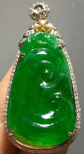 A GREEN JADEITE CARVED AUSPICIOUS PENDANT, TYPE A