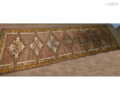 Caucasian runner, triple gull border, central panel of seven lozenges, mainly brown field with