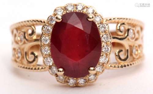 Modern ruby and diamond cluster ring set with an oval cut ruby, 3.10ct (est) within a diamond