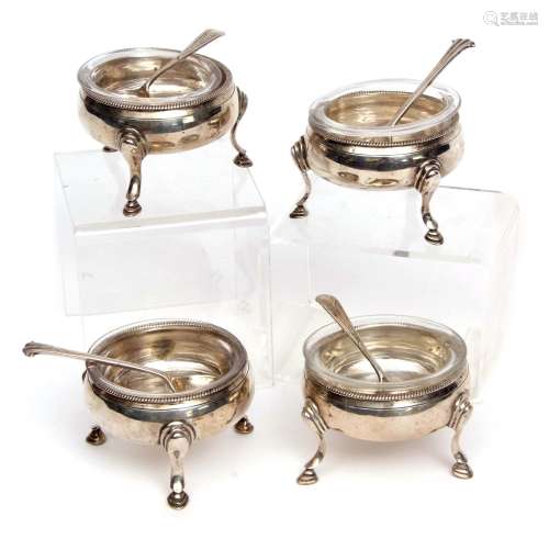 Four George III cauldron salts of plain polished form and raised on three cast and applied hoof feet