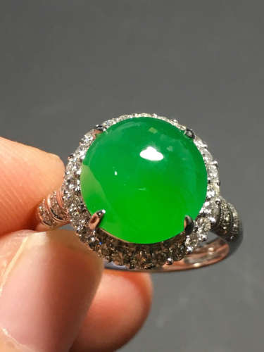 A GREEN JADEITE CARVED CIRCLE RING