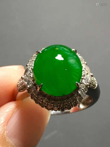 A GREEN JADEITE CARVED CIRCLE RING