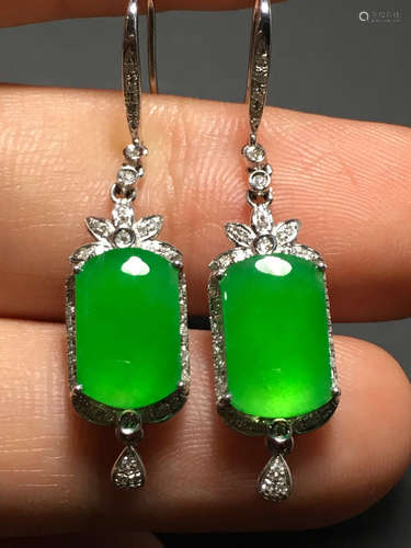 A GREEN JADEITE CARVED SADDLE SHAPED  EARDROPS