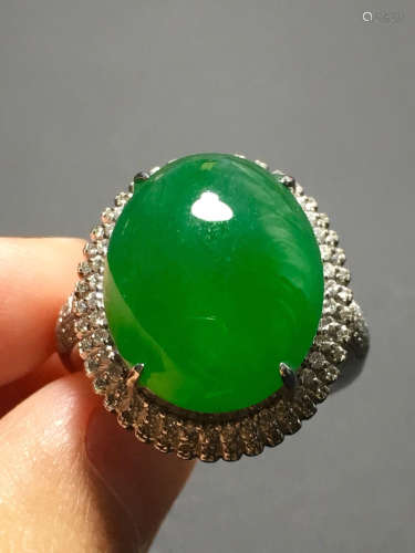 A GREEN JADEITE CARVED CIRCLE RING