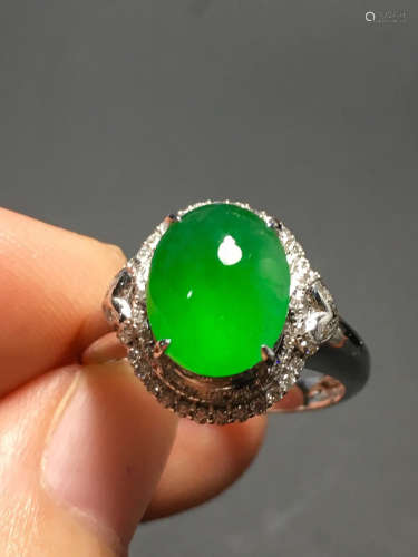 A GREEN JADEITE CARVED CIRCLE RING