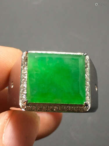 A GREEN JADEITE CARVED SQUARE RING