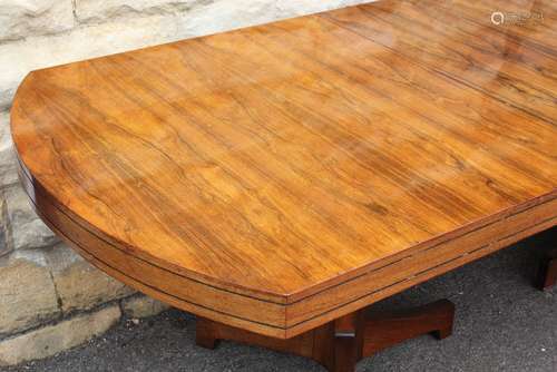 An Art Deco Rosewood Dining Table, the table raised on twin tripod pedestals, approx 272 l x 100 w  cms