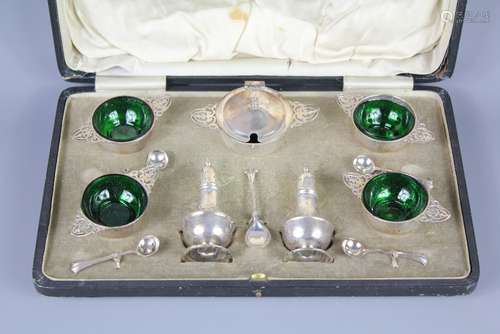 A George V Silver Cruet Set; London hallmark, dated 1929, mm Fullerton, the cruet set comprising four salts with Bristol green glass liners and four spoons, two peppers and a mustard pot with spoon, in the original presentation box