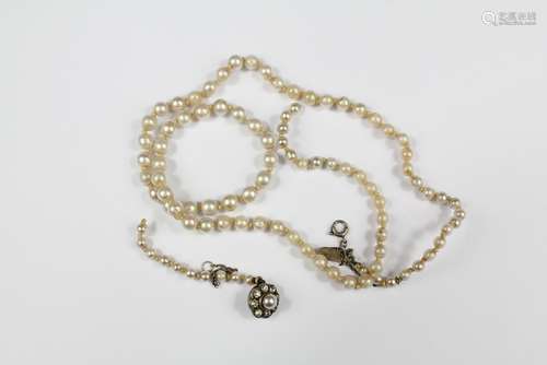 A Fine Graduated Pearl Necklace, approx 42 cms, with a floral clasp set with a single pearl