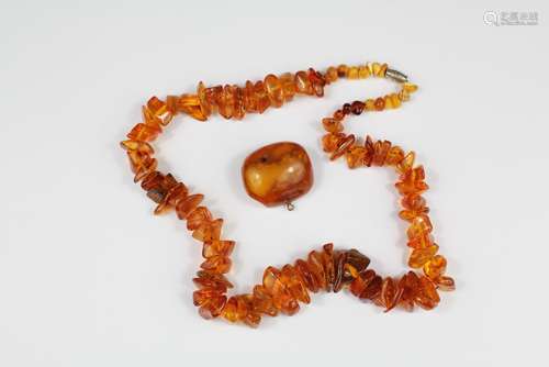 A Lady's Amber Necklace, approx 46 cms length together with an amber brooch, approx 35 x 35 mm